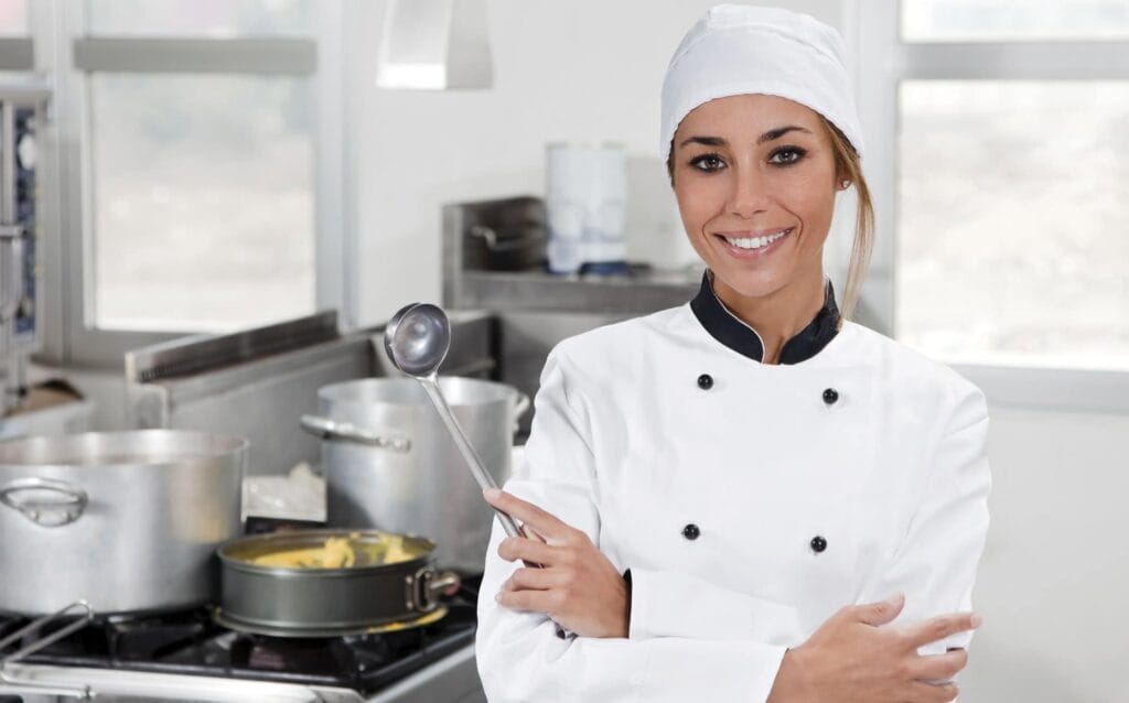Confident chef in a commercial kitchen — qualified Food Safety Supervisor